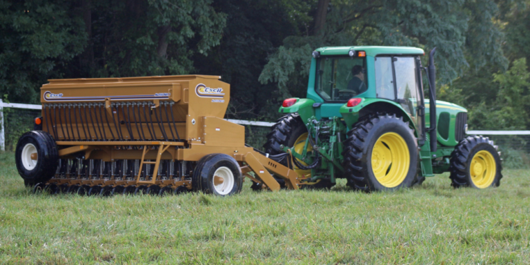 John Deere pulling Esch no-till drill to overseed a pasture